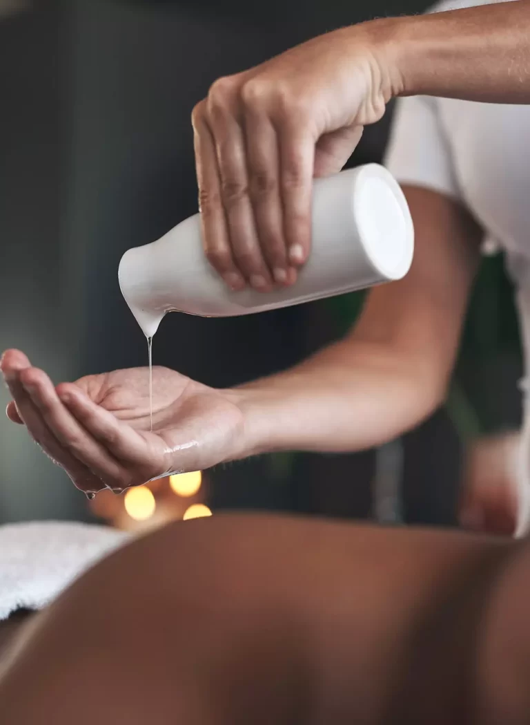 Pouring massage oil into hand for massage