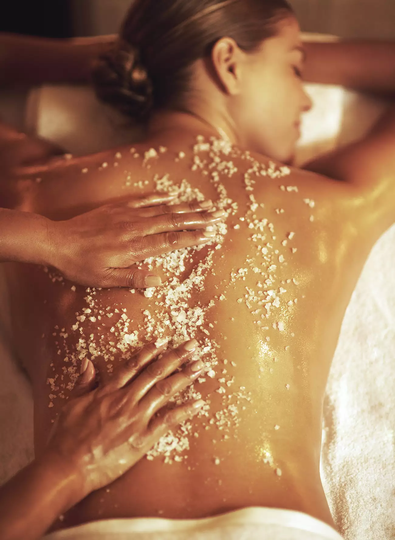 Salt exfoliation scrub massage on back