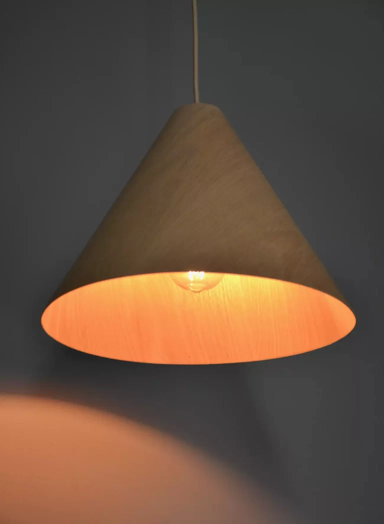 Timber pendant light casting a light shadow on wall
